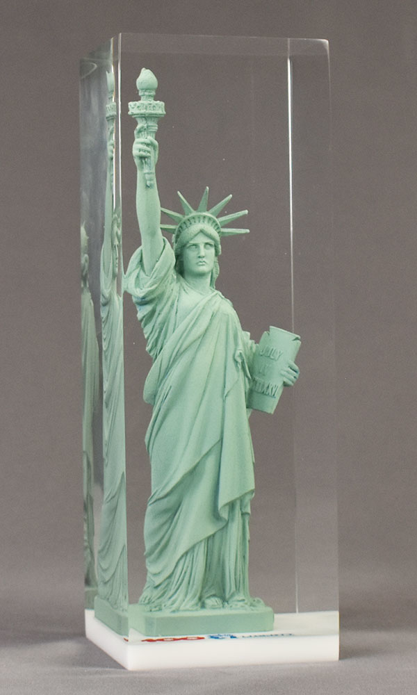 Miniature Statue of Liberty deal toy cast into lucite embedment.